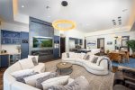 The open concept living area is embellished with custom lighting.